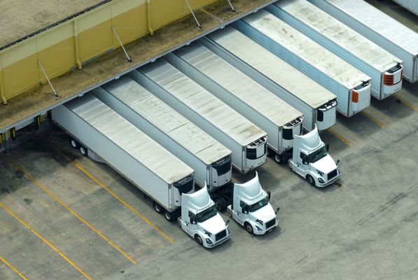 Trucks docked at a warehouse from at 3/4 vertical view